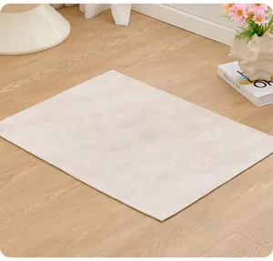Detailed close-up of a textured cream non-slip pet sleeping mat on wooden floor.