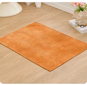 Soft orange pet mat with embossed floral pattern shown on wooden floor detail view