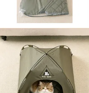 Detail view of a dark green foldable pet tent showing its sturdy frame and a cozy cat inside