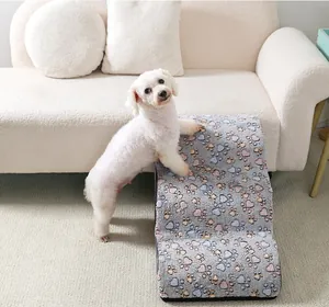 Soft plush pet ramp with paw pattern for small dogs climbing onto a white sofa
