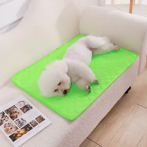 Bright green washable absorbent pet cooling mat for puppy dog on white sofa lifestyle view