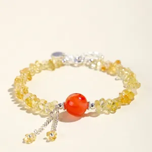 Bracciale artigianale in cristallo giallo irregolare con una perla di corniola rossa