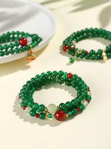 Close-up of ethnic style multi-layer wrap bracelet with green and red agate beads