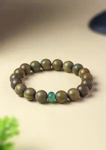 Close-up of green sandalwood beaded bracelet with natural aventurine jade stone
