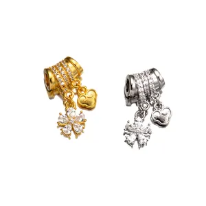 Detail showing 925 sterling silver petal and heart charms in gold and silver finish