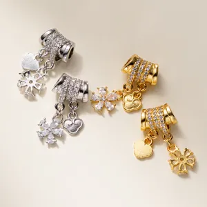 Detail view of 925 sterling silver barrel charms with CZ heart and flower dangles