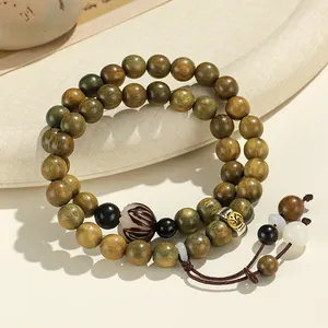 Double-strand green sandalwood beaded bracelet with carved guardian buddha symbol