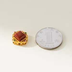 Macro detail of red agate pendant in gold plated 925 silver frame for DIY jewelry