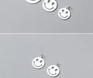 Close-up of minimalist silver hollow smiley face charms for handmade DIY jewelry making.