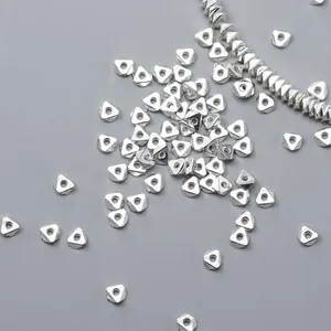 Macro shot of geometric 925 sterling silver triangle spacer beads for DIY jewelry