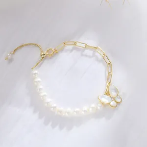 Elegant detail of freshwater pearl bracelet with gold chain and butterfly charm