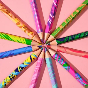 Macro view of 12 triangular colored pencils arranged in a starburst pattern on pink