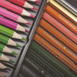 Detailed close-up of 72 professional colored pencils set in a premium tin box for art.