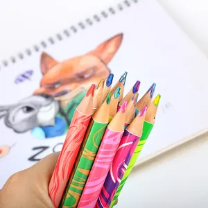 Close-up detail of multi-colored triangle colored pencils held over a creative sketchbook