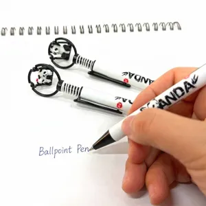 Cute panda ballpoint pen with panda topper being used for smooth writing on white paper