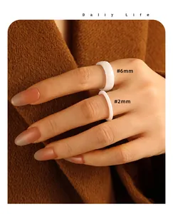 Detail view of faceted white ceramic rings in 2mm and 6mm widths for stacking