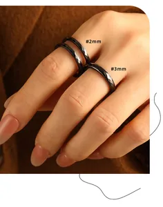 Detail view showing faceted black ceramic rings in 2mm and 3mm widths on fingers.