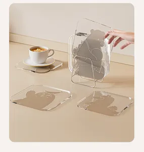 Close-up of thick transparent acrylic coasters with cute animal patterns and metal rack