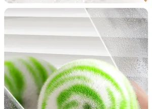 Macro detail of a green and white spiral bathroom cleaning brush with soft bristles.
