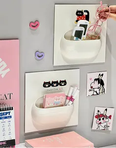 Close-up of wall-mounted storage rack with cute cartoon cat design for small items