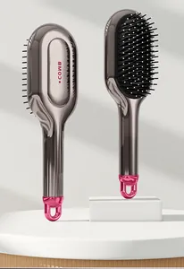 Metallic gunmetal air cushion hairbrush with pink handle loop for scalp massage and styling.