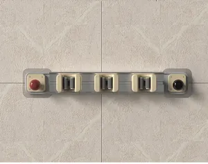 Wall-mounted sliding mop and broom holder with punch-free adhesive design for home organization