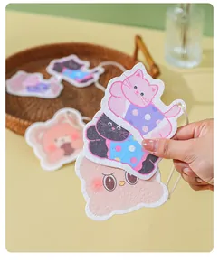 Close-up of cute cartoon cat and bear shaped compressed wood pulp sponges for cleaning
