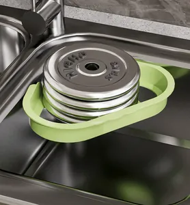 Green triangular sink drain basket holding heavy weights to show durability