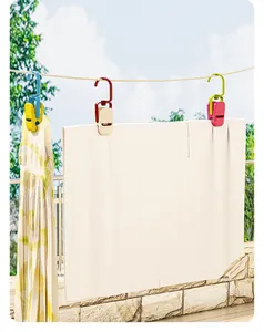 Detailed view of colorful windproof plastic clothes clips hanging a towel on a clothesline