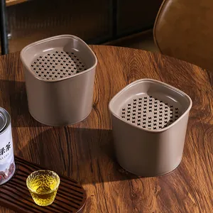 Modern tea dregs filter desk trash cans on a rustic wooden table detail