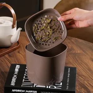 Close-up of the functional strainer lid on a mini desktop trash can for tea dregs