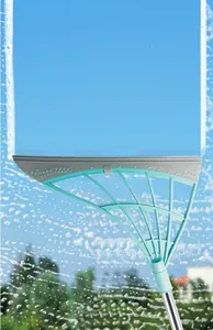 Multisurface silicone squeegee broom cleaning foam on a clear glass window outdoors