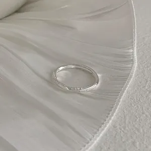 Macro detail of the minimalist 925 sterling silver open ring with subtle engravings