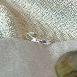 Close-up of a 925 sterling silver open ring with unique irregular lava texture
