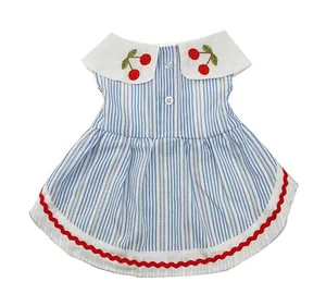 Detailed view of striped pet dress featuring cherry embroidery and red wavy hemline.