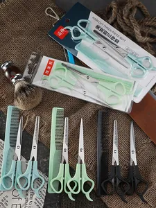 Detail view of colorful haircut sets with stainless steel scissors and combs