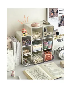Cream modular desktop storage drawers stacked neatly with various stationery items