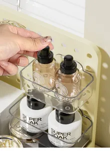 Detailed close-up of a transparent storage box mounted on a cream pegboard shelf