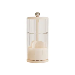 Cream-colored minimalist rotating makeup brush holder with a clear protective dust lid