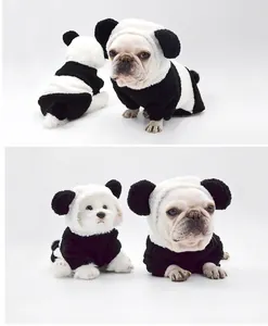 Cute French bulldog and small white puppy wearing fuzzy black and white panda dog hoodies