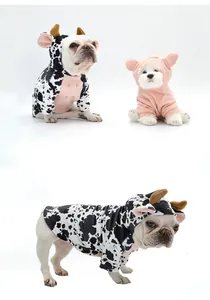 Detailed view of two dogs wearing cute cow and pig themed Halloween costumes