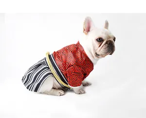 Profile view of a French Bulldog wearing a red and black Japanese samurai kimono costume