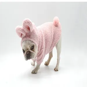 Detailed view of a pink fuzzy rabbit hoodie costume worn by a French Bulldog model