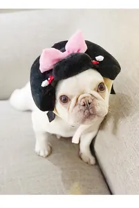 Detailed macro view of a plush Japanese geisha-style pet hat worn by a white bulldog