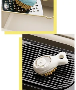 Close-up of liquid-dispensing cleaning brush with soft bristles and ergonomic handle