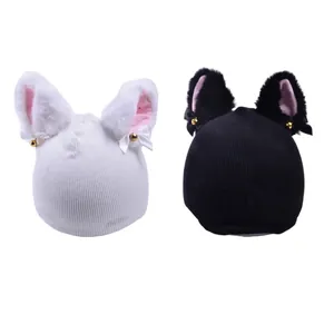 Close-up view of cute knitted cat ear helmet decorations in black and white colors