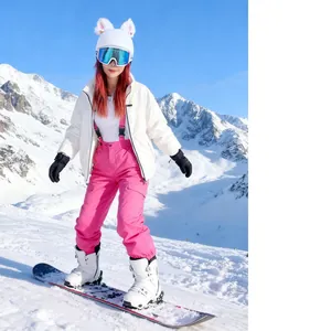 Cute white plush cat ear decorations on a ski helmet cover worn by a snowboarder