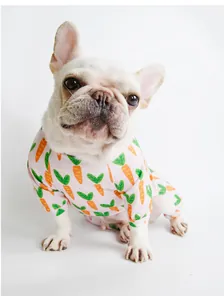 Detail of pink cotton pet pajamas with carrot pattern on a French Bulldog sitting