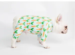 Side view of a white French Bulldog wearing light blue carrot print four-legged pet pajamas.