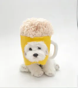 Detailed view of a fluffy dog wearing a yellow beer mug hat with foam top for Halloween.